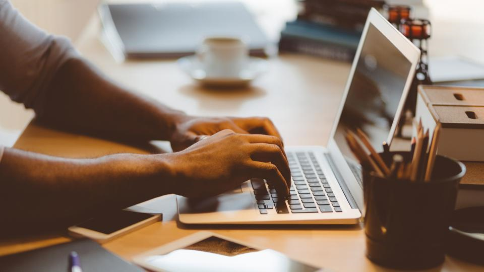 Top Online Business Ideas for Beginners in 2026 Professional blogger writing SEO-friendly content on a laptop